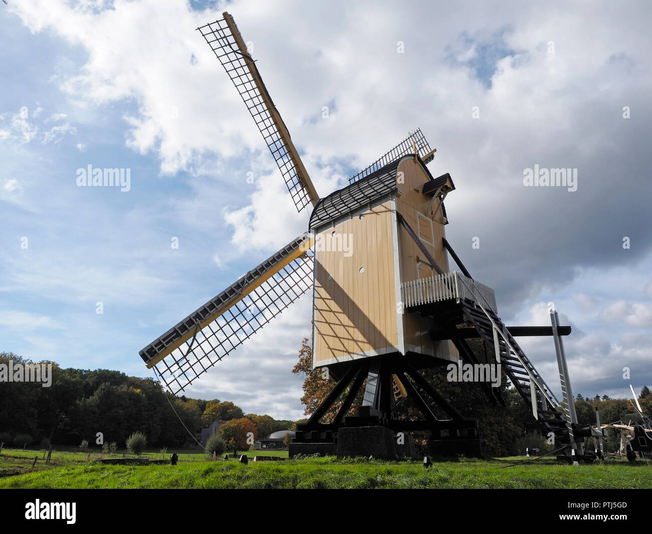 Old Dutch windmill of a specific type that is standing on a frame so the whole windmill can rotate photographed in the dutch open air museum in Arnhem Stock Photo