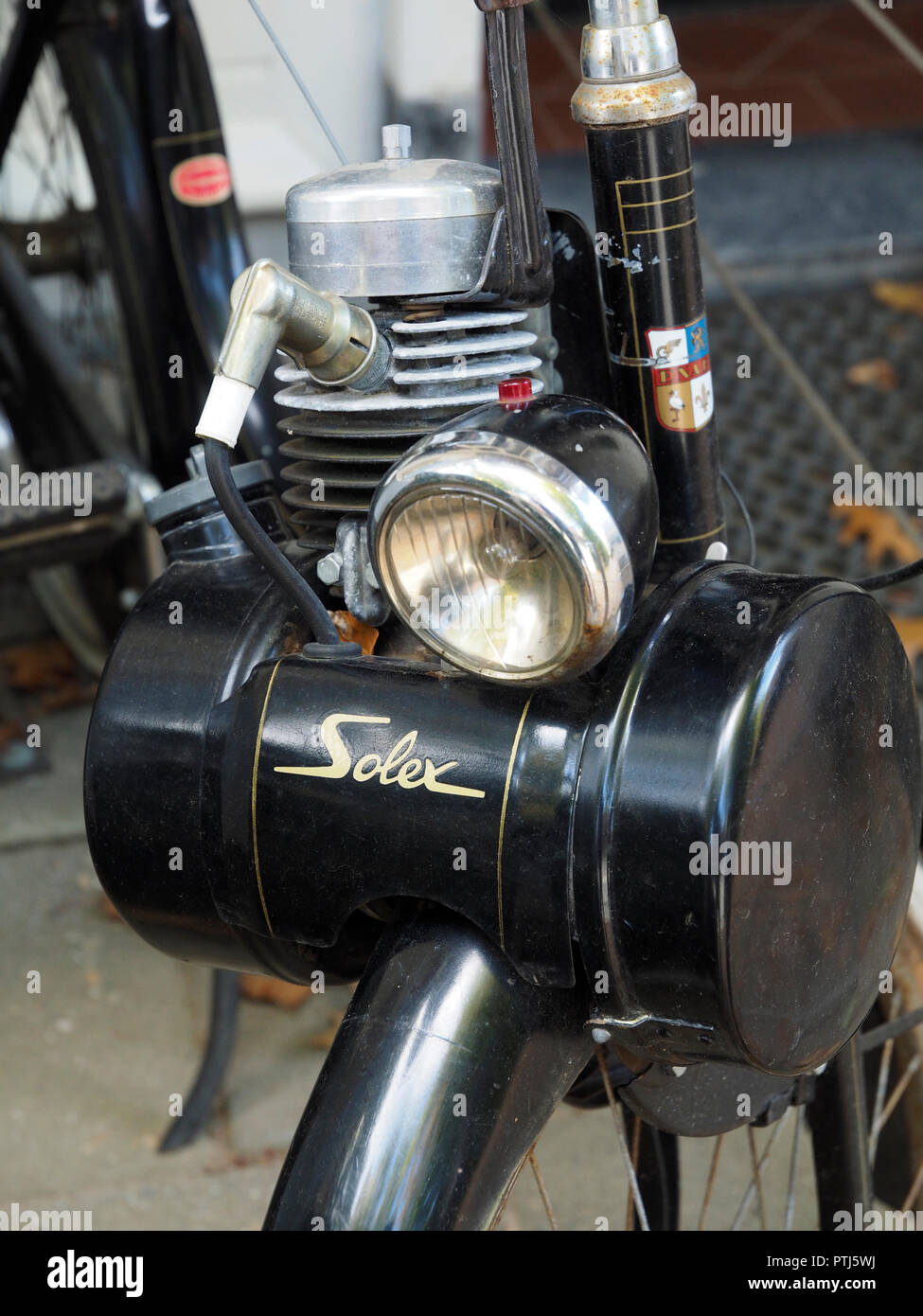 Closeup of classic Solex moped motorized bicycle engine on top of the front wheel Stock Photo