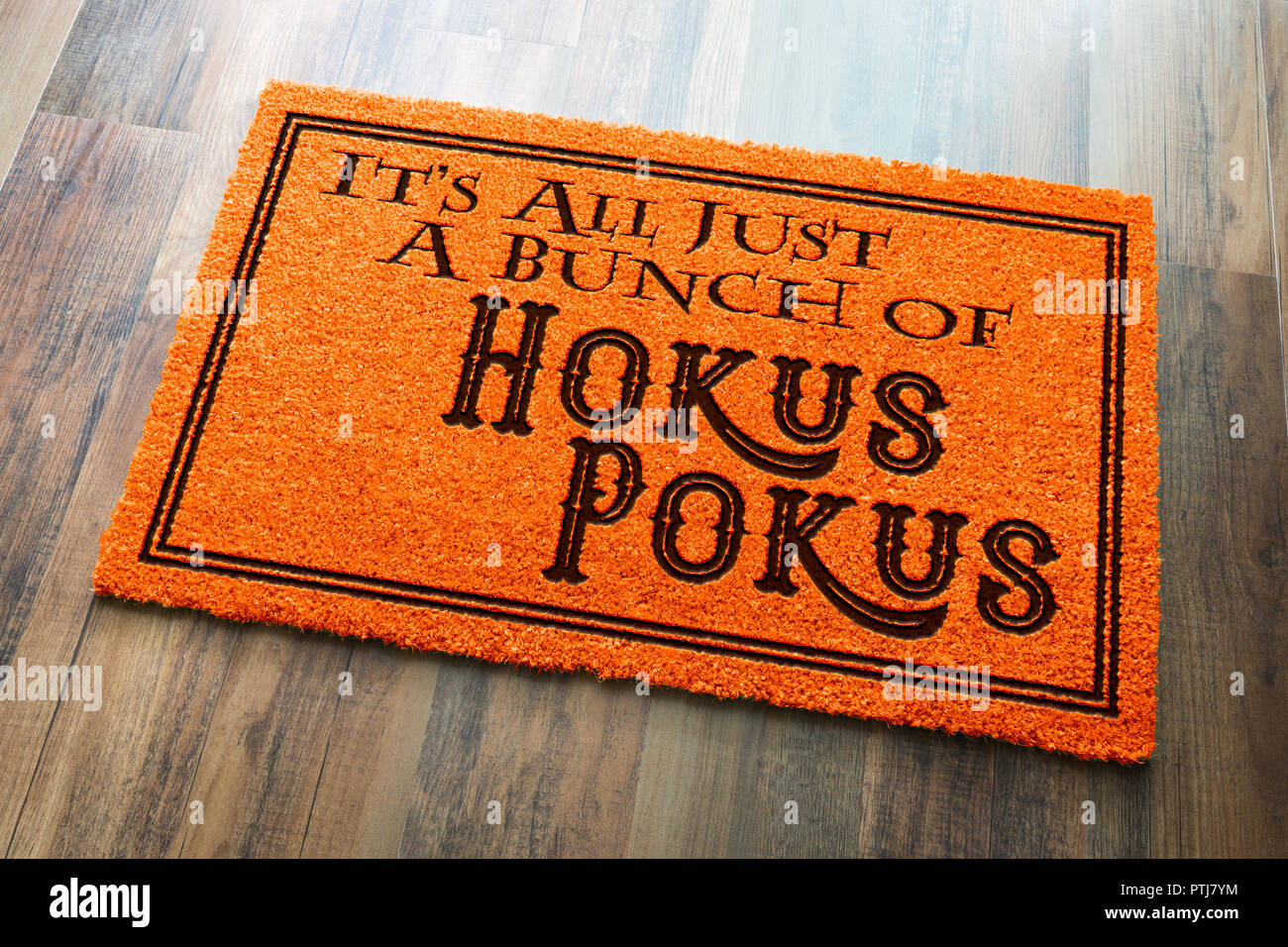 It's All A Bunch Of Hokus Pokus Halloween Orange Welcome Mat On Wood Floor Background. Stock Photo