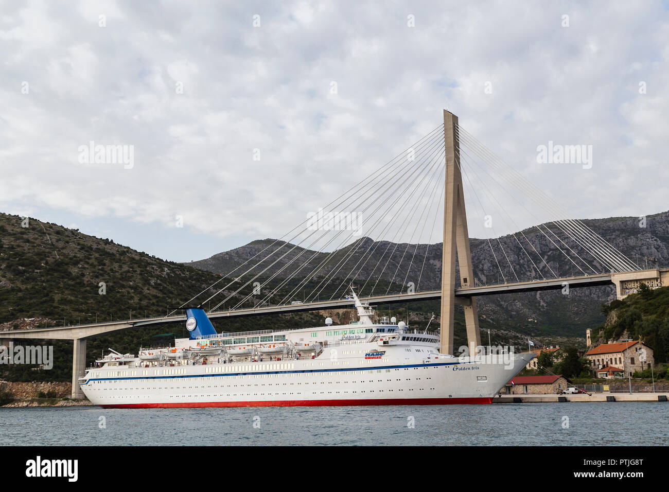 Boat by Dubrovniks suspension bridge. Stock Photo