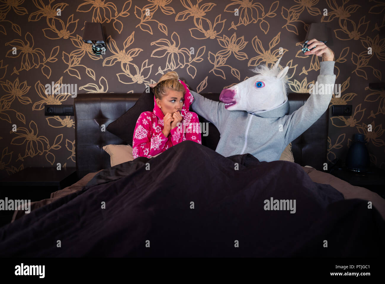 Scared Girl Is Lying With Funny Boyfriend In Comical Mask