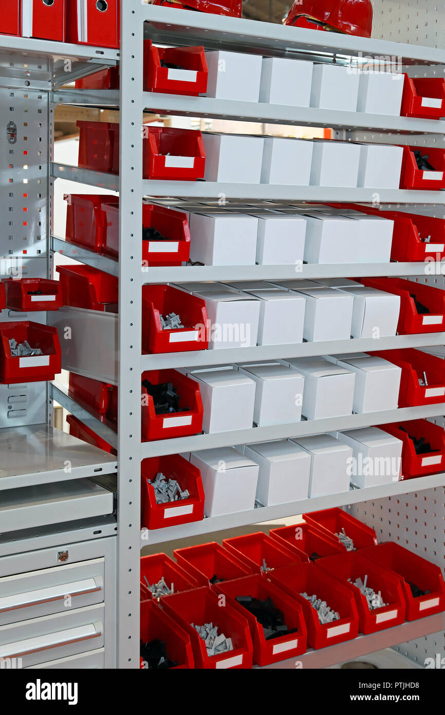 Red bins with parts at shelf in warehouse Stock Photo Alamy