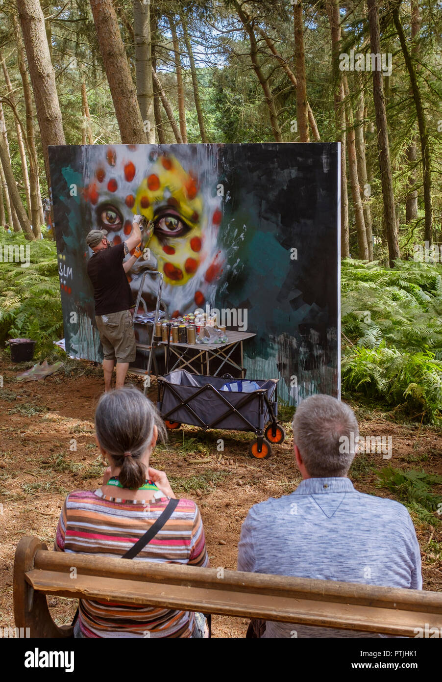 Painting in the woods at the Latitude festival in Henham Park. Stock Photo