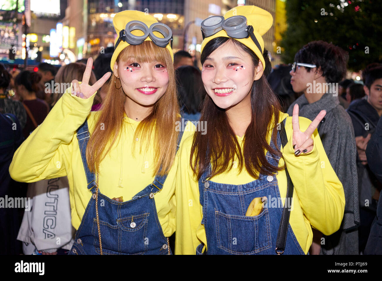 Young Japanese girls dressed as minions at the Halloween celebrations in Shibuya. Stock Photo