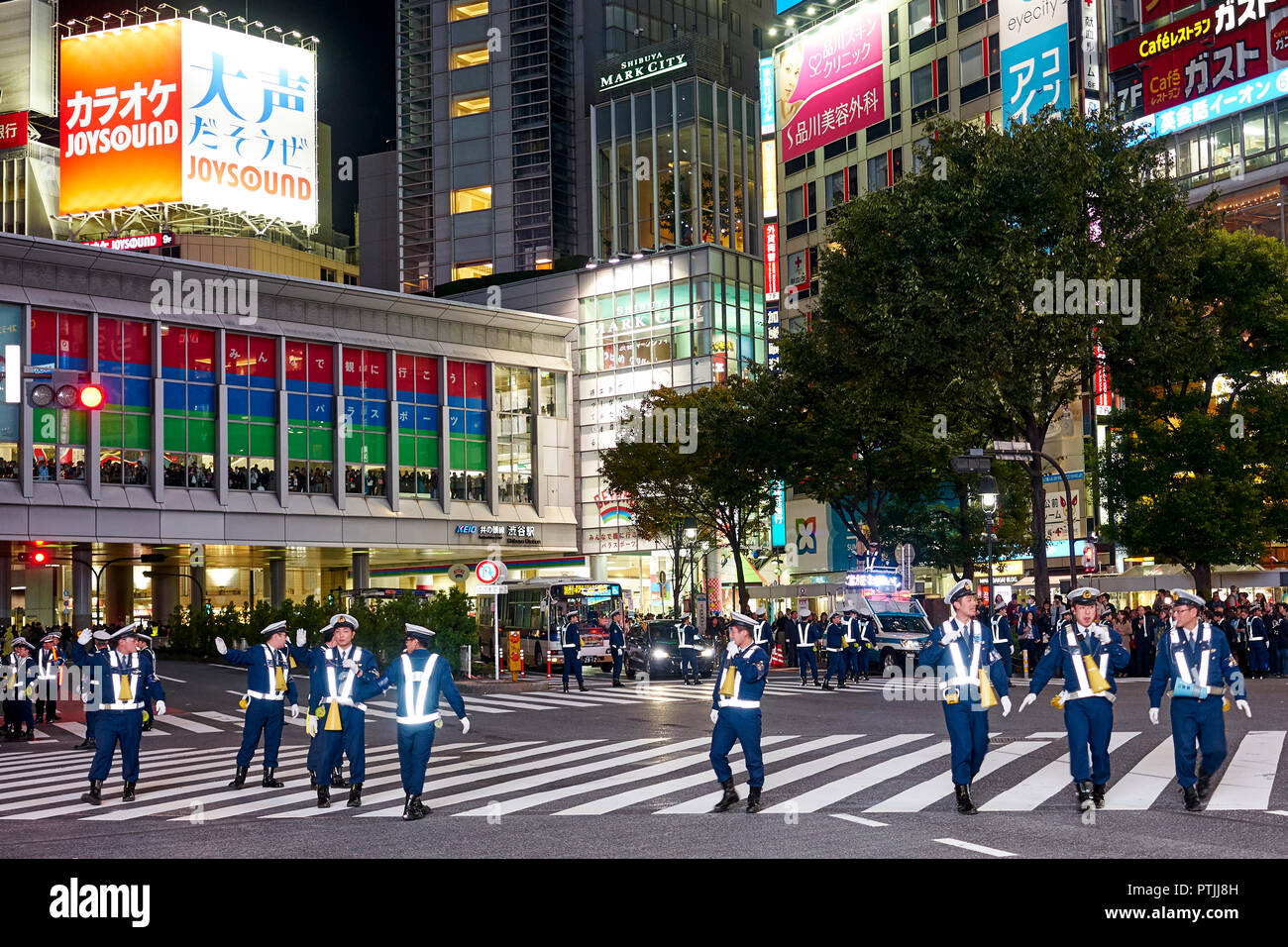 Police controlling the crowds of people during the Halloween celebrations in Shibuya. Stock Photo