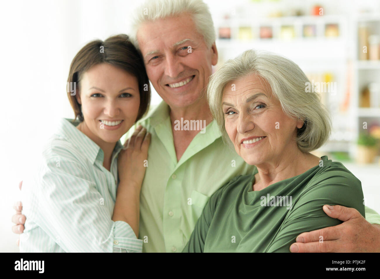 Happy senior parents with daughter at home  Stock Photo