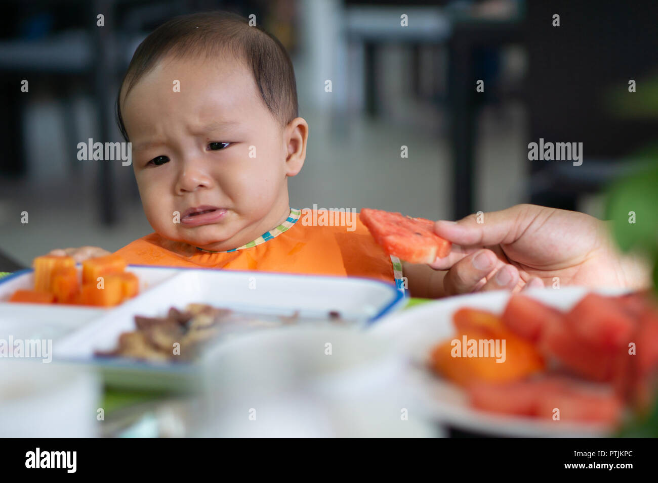Cute 56 month asian baby girl doesn't want to eat watermelon Stock Photo Alamy