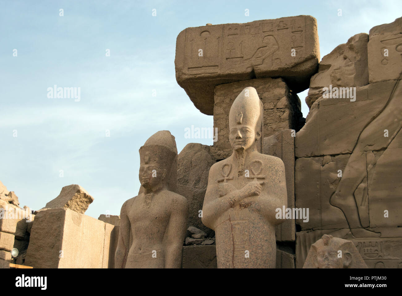A statue of a pharaoh holding two ankhs, at the Karnak Temple complex at Luxor, Egypt. Stock Photo