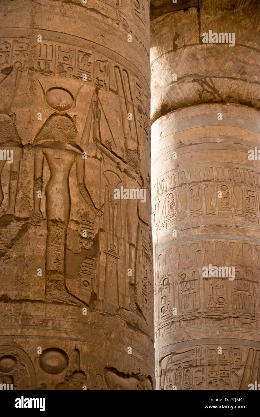 Bas relief images of Egyptian gods and hieroglyphs carved on a column at the Karnak Temple at Luxor, Egypt. Stock Photo