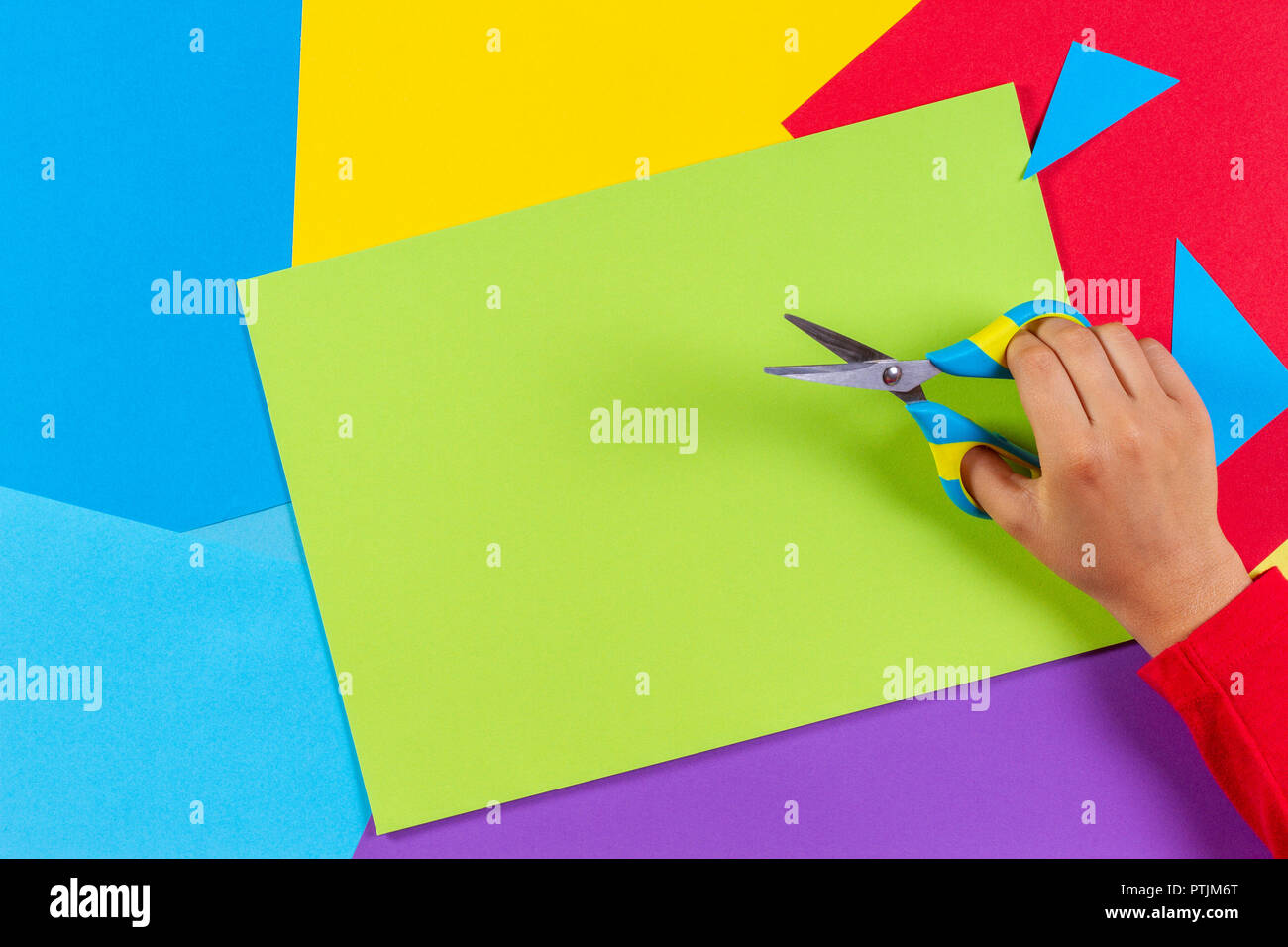 Kid's hands cutting colored paper with scissors Stock Photo Alamy