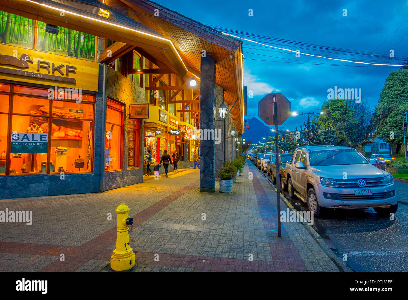 PUCON, CHILE - SEPTEMBER, 23, 2018: Outdoor view of cars parked in a row in the streets of the city in Pucon at night Stock Photo