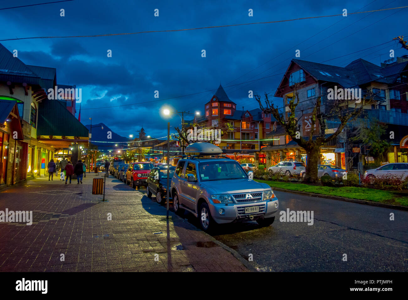 PUCON, CHILE - SEPTEMBER, 23, 2018: Outdoor view of cars parked in a row in the streets of the city in Pucon at night Stock Photo