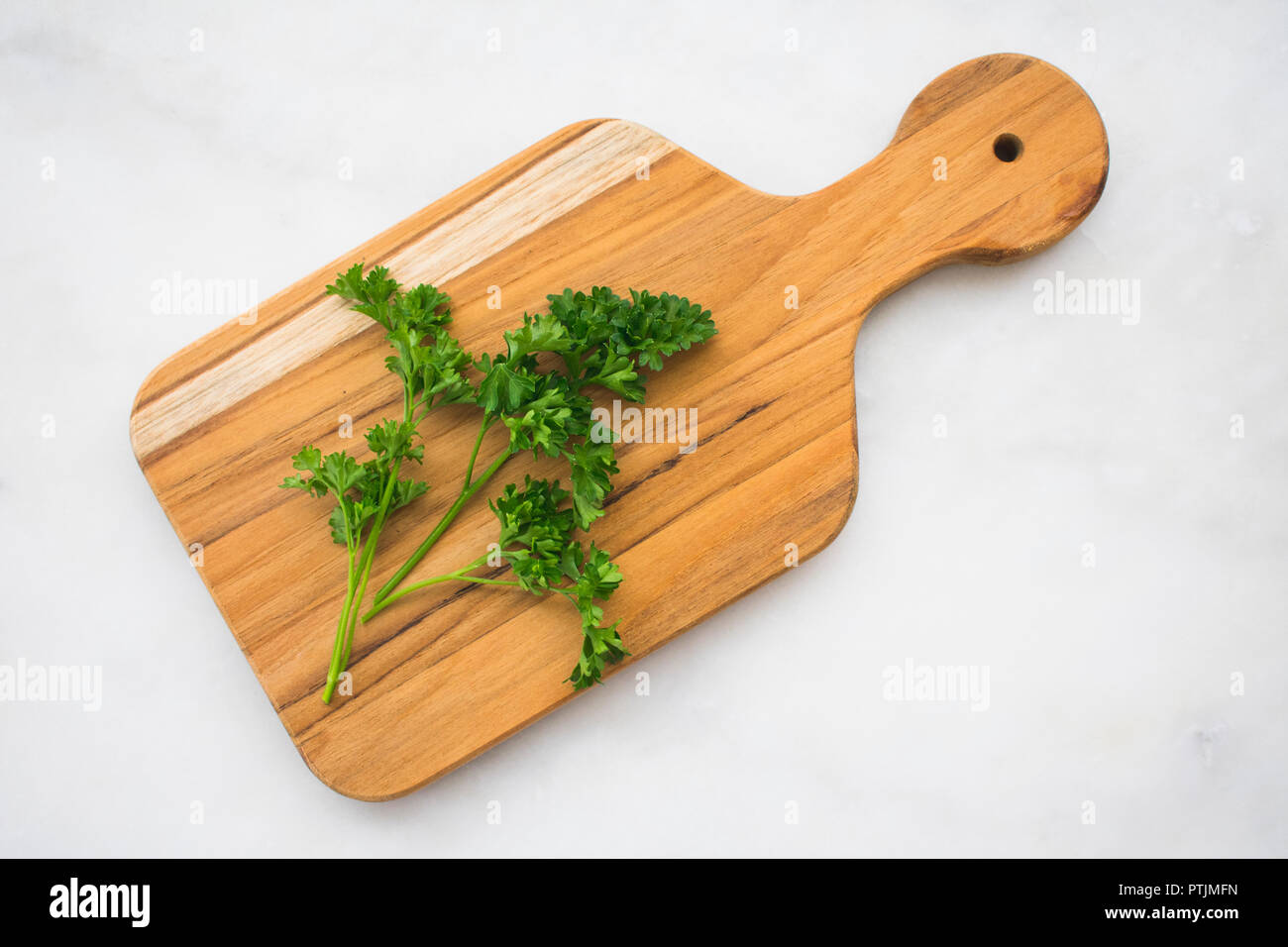Parsley Sprigs on a Cutting Board Stock Photo