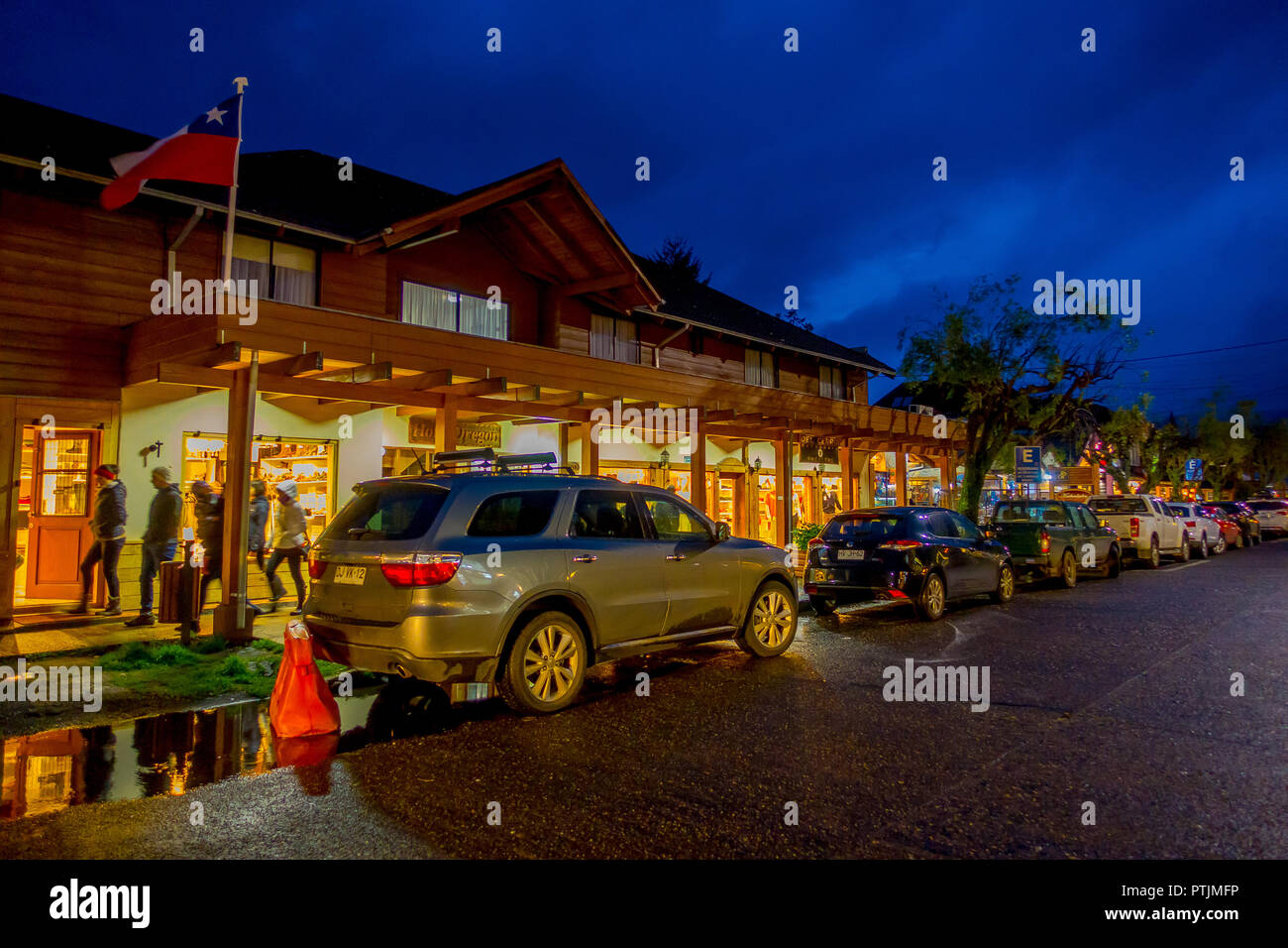 PUCON, CHILE - SEPTEMBER, 23, 2018: Outdoor view of cars parked in a row in the streets of the city in Pucon at night Stock Photo