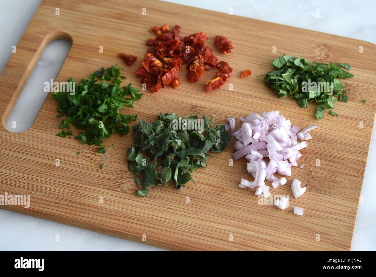 Chopped Herbs on a Cutting Board Stock Photo