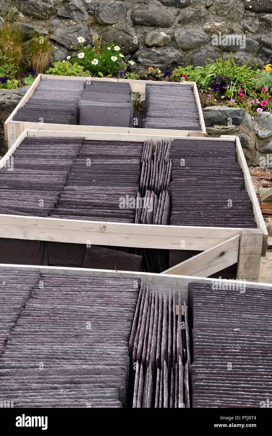 Boxes of new slate roof tiles at a rock wall flower garden in Crovie Banff Aberdeenshire Scotland UK Stock Photo