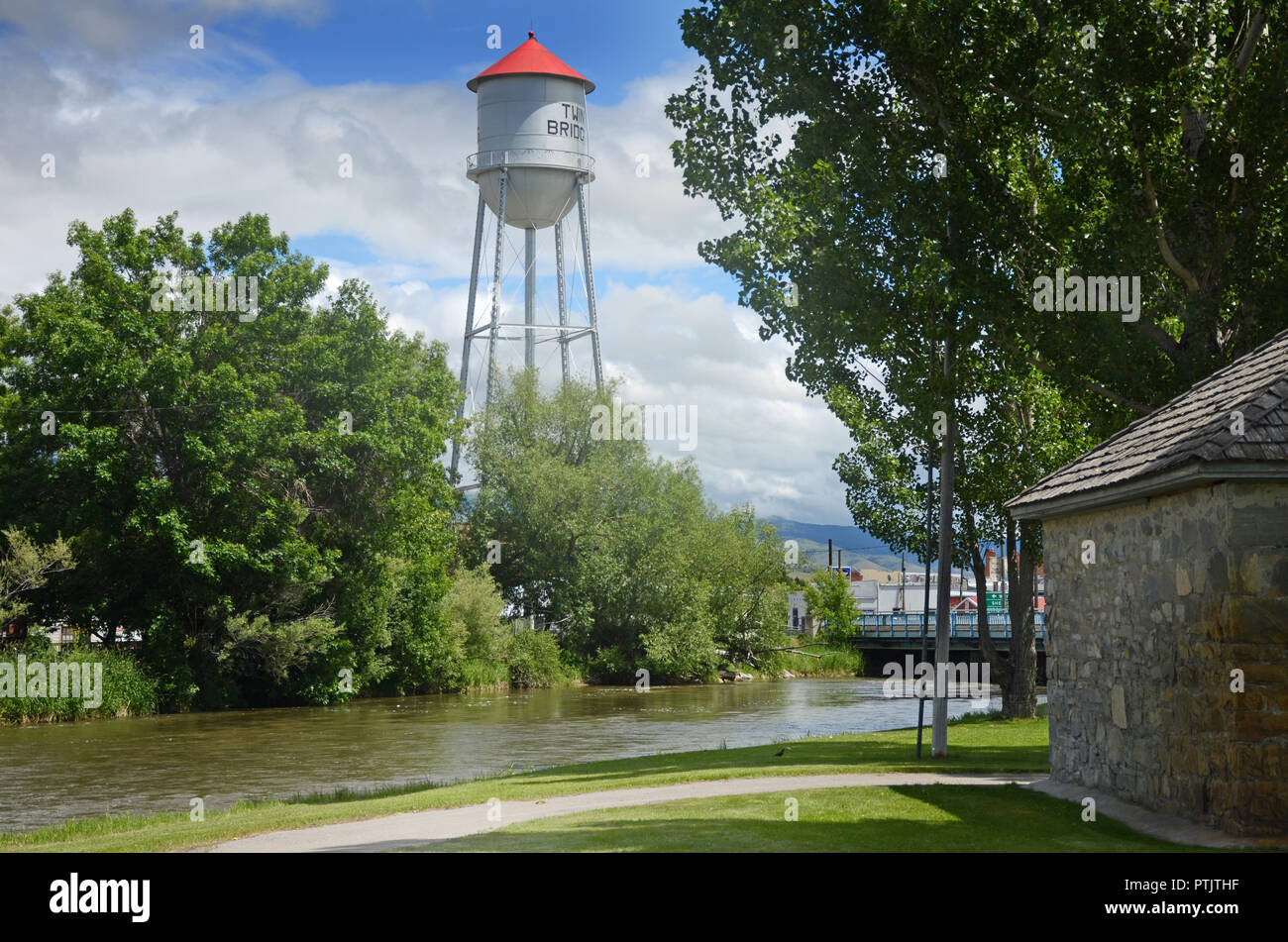 Water tower for the town of Twin Bridges, Montana with the Beaverhead River flowing through the town park. Stock Photo