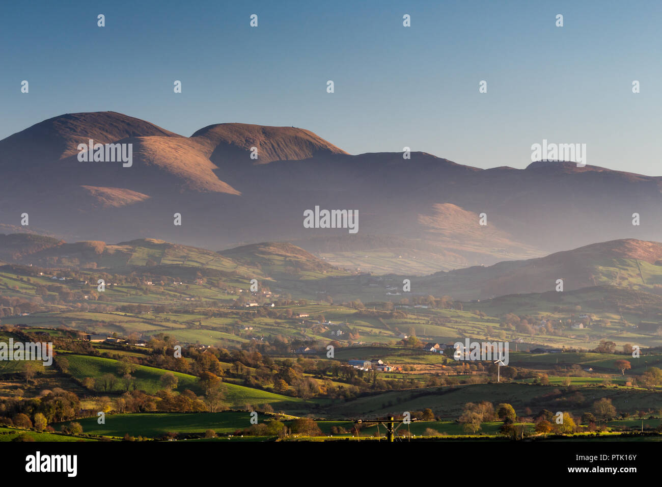 Mourne Mountains (Slieve Donard,  Slieve Commedagh & Slieve Corragh) with mist in evening light viewed from the summit of Windy Gap in the Dromara hil Stock Photo