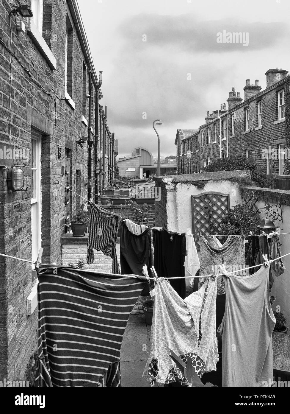 Washing hanging in the back yards of terraced houses at Saltaire, Bradford, Yorkshire Stock Photo