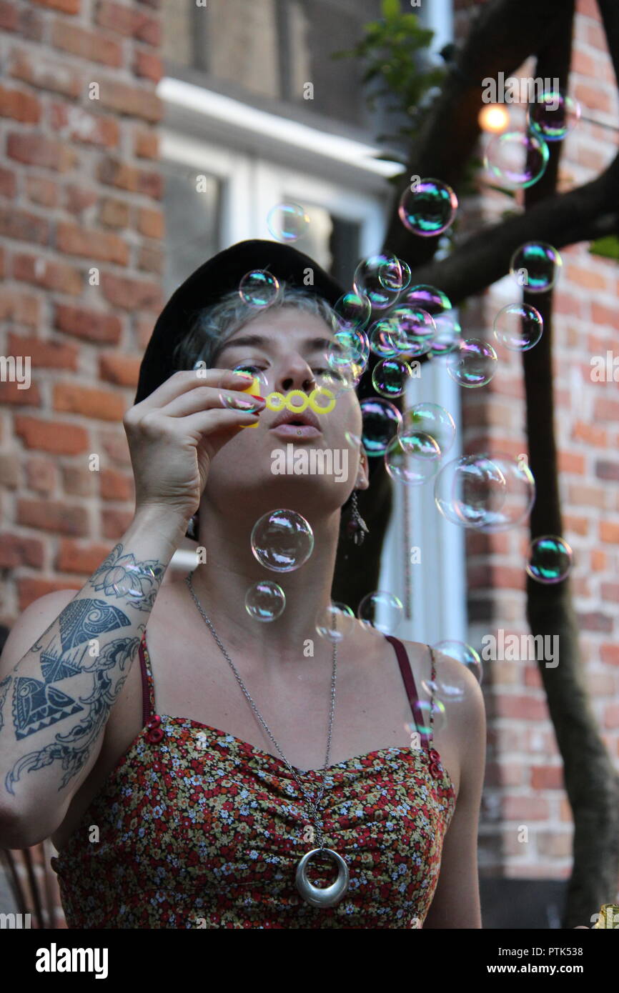 Beautiful woman with soap bubble and bubbles. Stock Photo