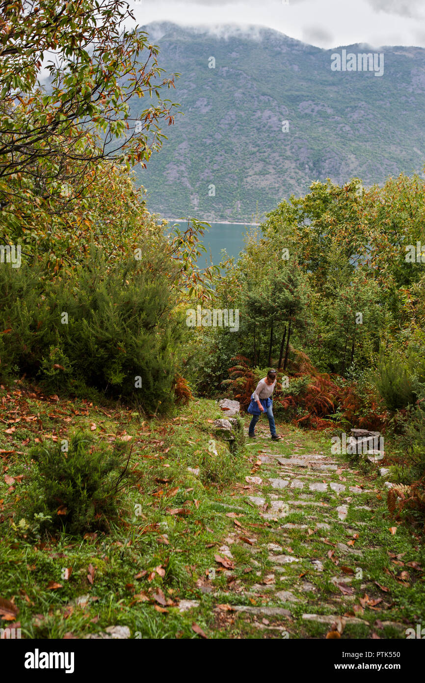 Female hiker on the steep path up to Gornji Stoliv from the coast road round Boka Kotorska, Montenegro.  MODEL RELEASED Stock Photo