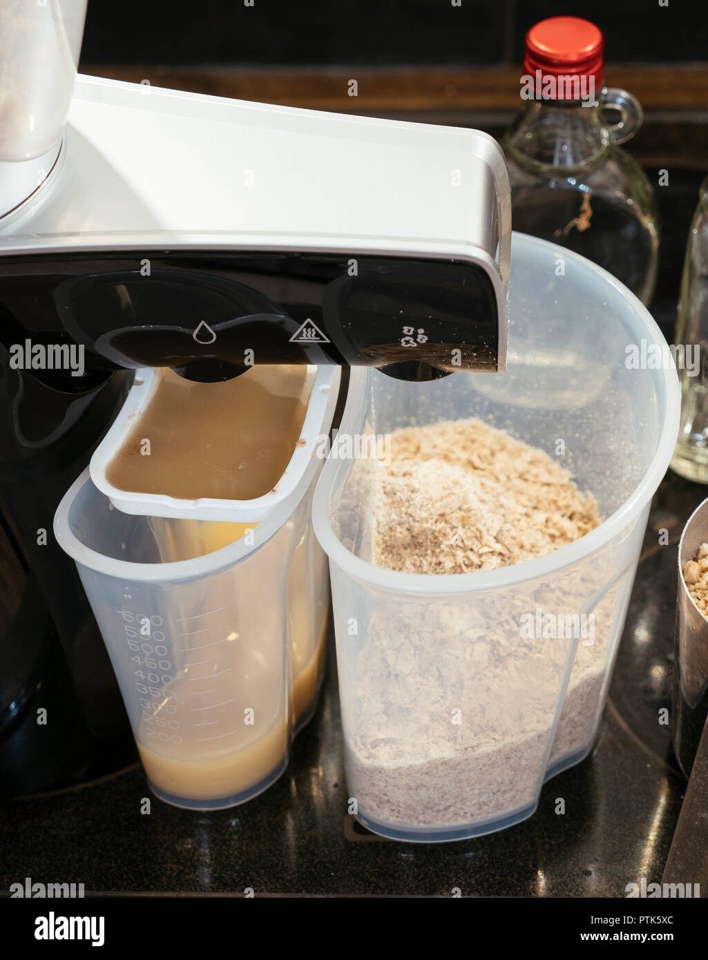 Homemade coldpressed walnut oil being extracted by an oil press