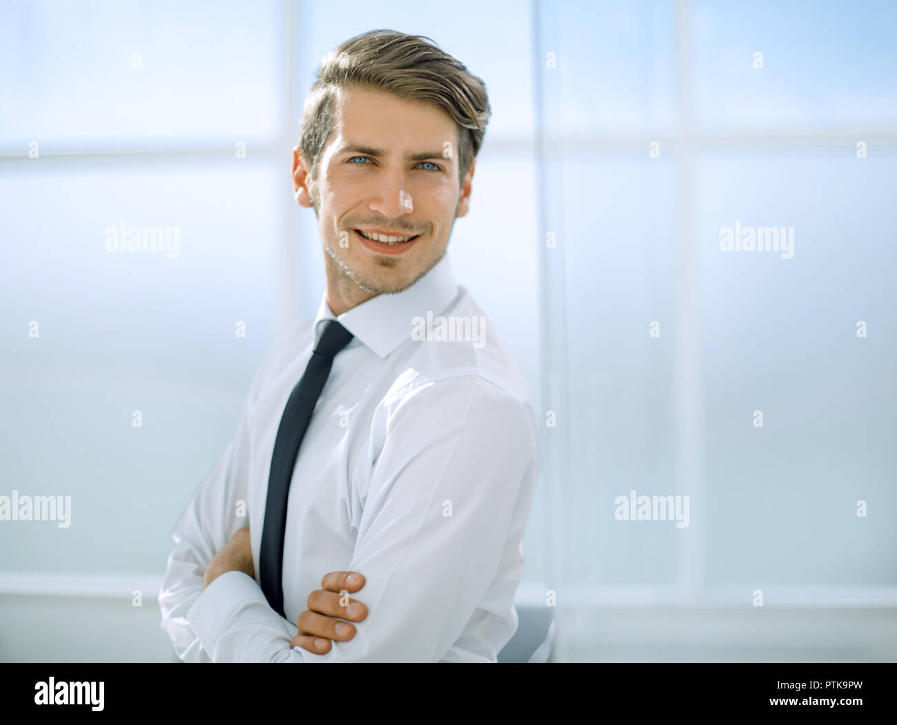 smiling businessman standing near the office window Stock Photo - Alamy