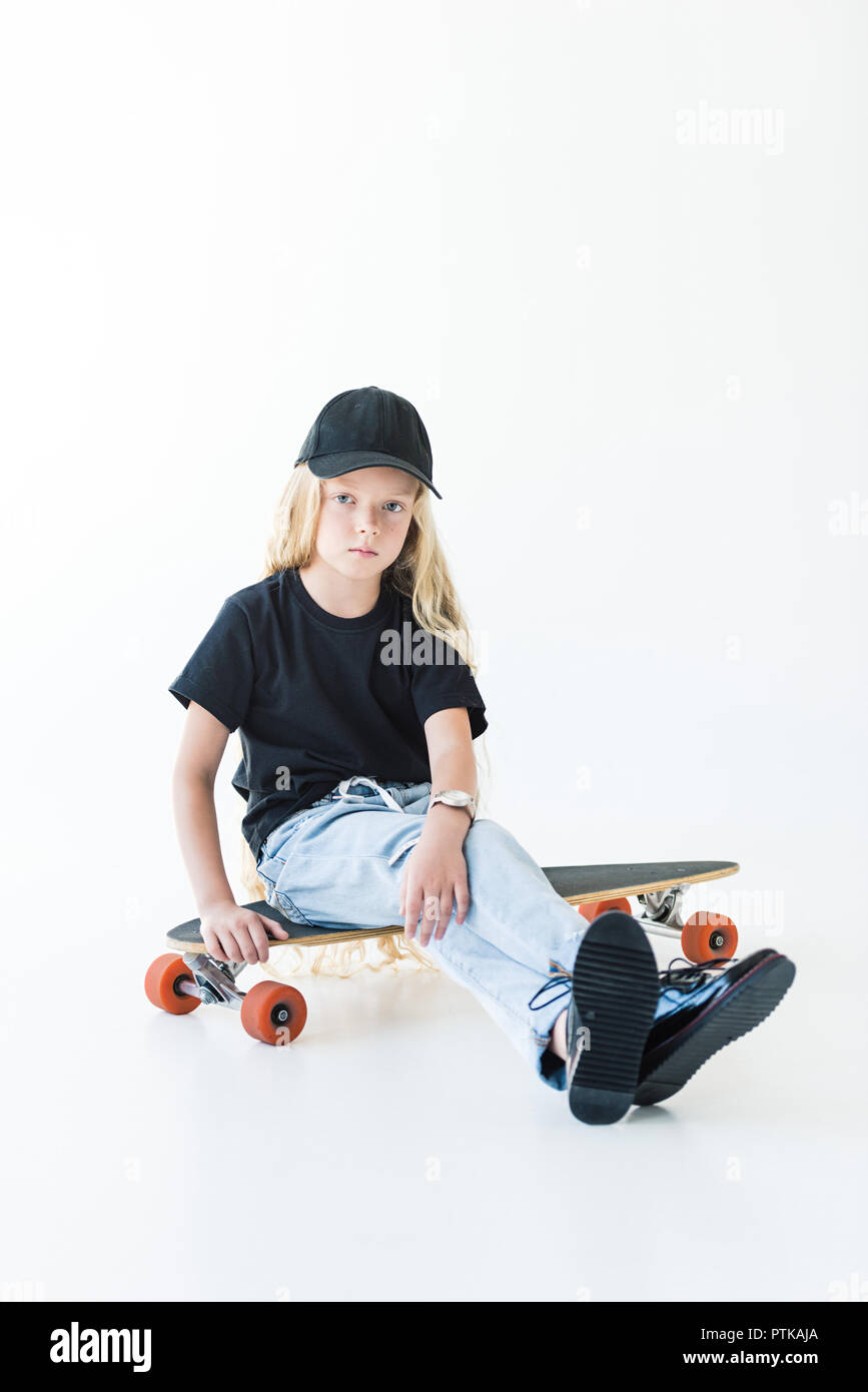 Adorable Child With Long Curly Hair Sitting On Longboard And Looking At Camera Isolated On White Stock Photo Alamy