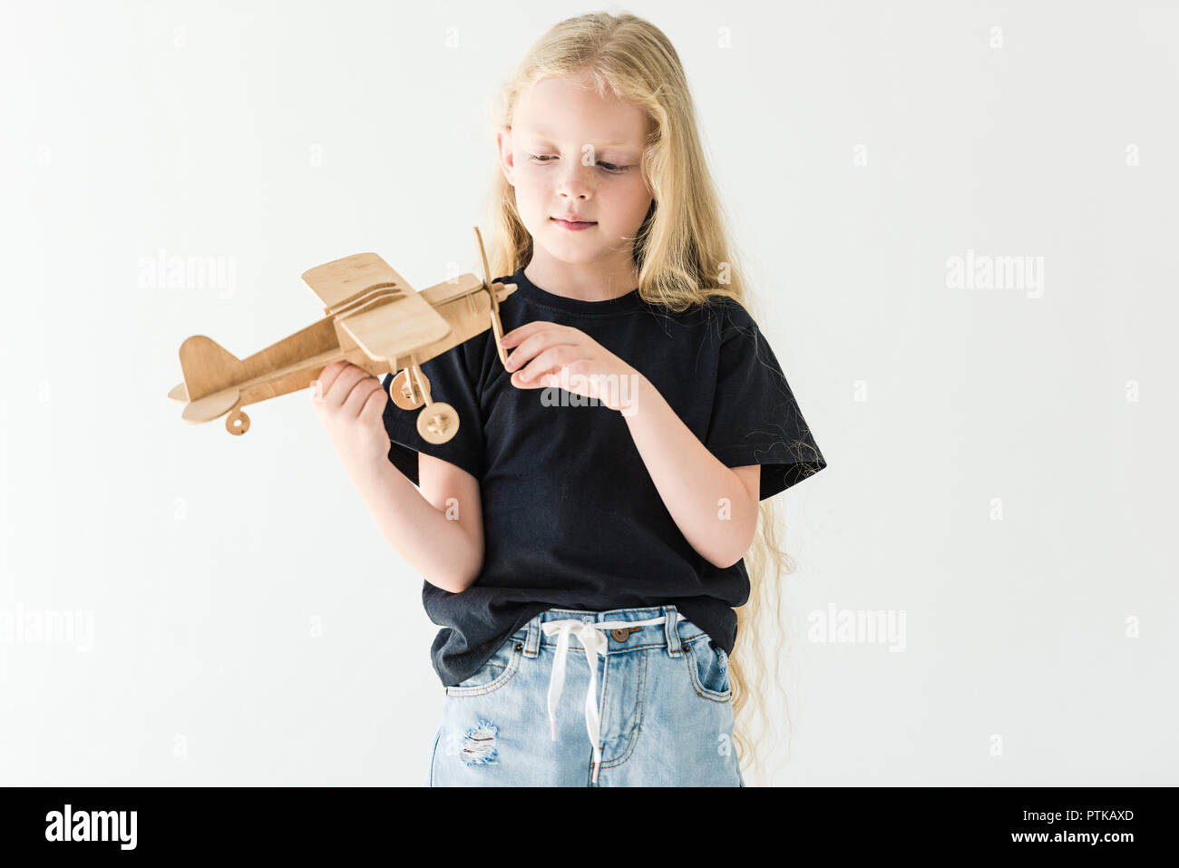 beautiful little kid playing with wooden toy plane isolated on white ...