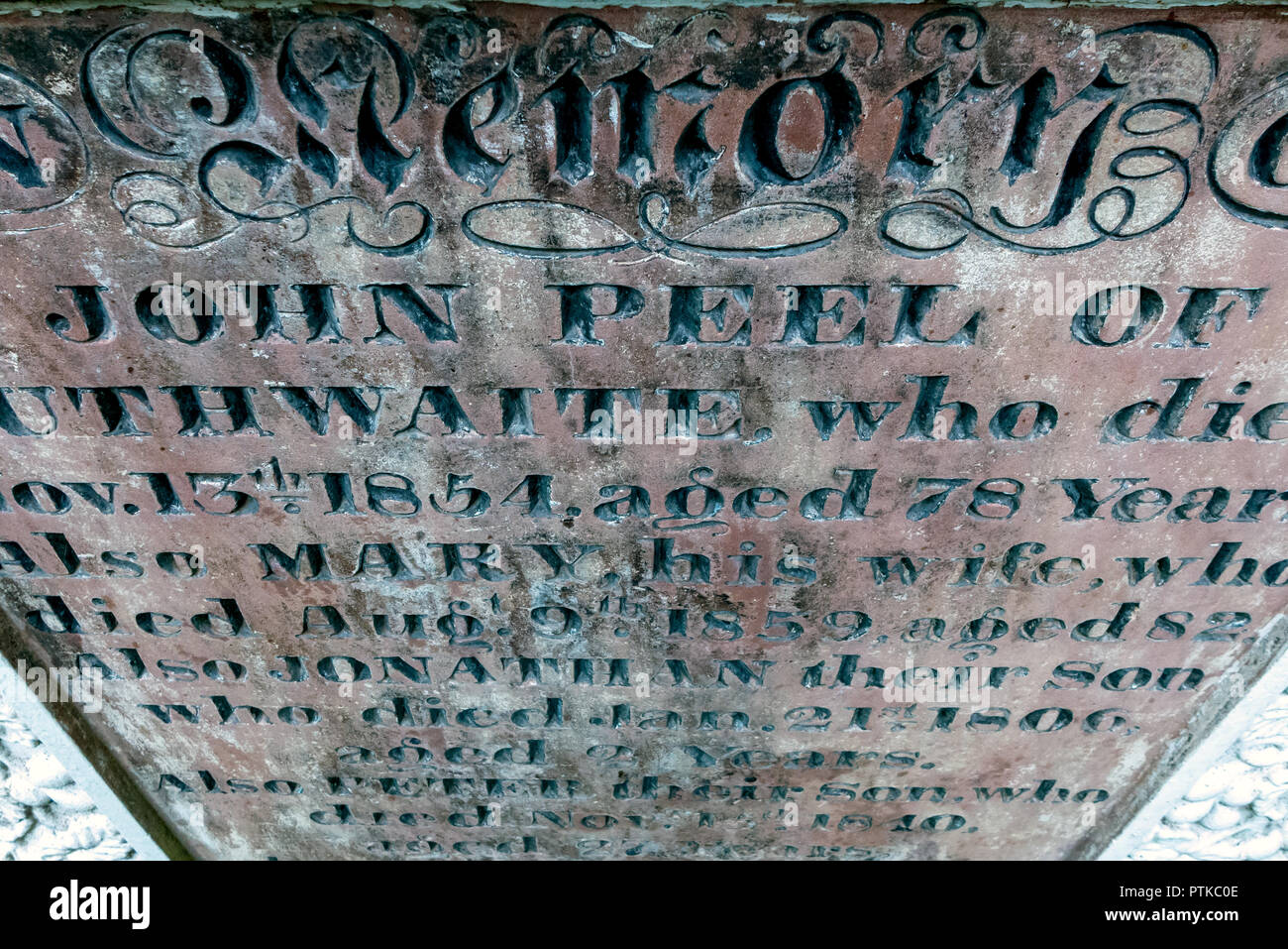 The gravestone of famous huntsman John Peel in St Kentigern's churchyard in Caldbeck in The Lake District Stock Photo