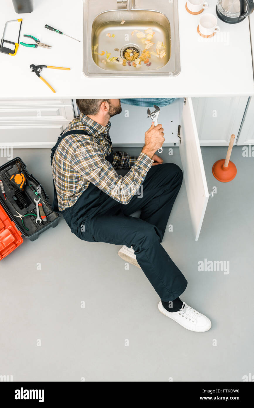 Caucasian Plumber Worker Wearing Safety Gloves Adjusting Water Sewage  Residential Stock Photo by ©welcomia 415928518