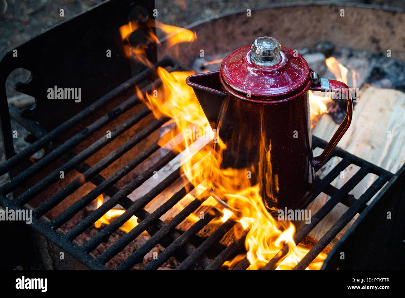 https://c8.alamy.com/comp/PTKFTR/enjoying-a-cup-of-coffee-over-a-campfire-in-the-early-morning-at-sunrise-while-camping-at-lake-crescent-in-washington-PTKFTR.jpg