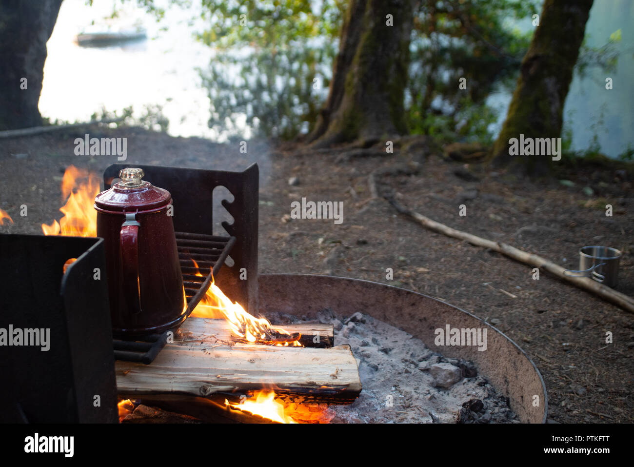https://c8.alamy.com/comp/PTKFTT/enjoying-a-cup-of-coffee-over-a-campfire-in-the-early-morning-at-sunrise-while-camping-at-lake-crescent-in-washington-PTKFTT.jpg
