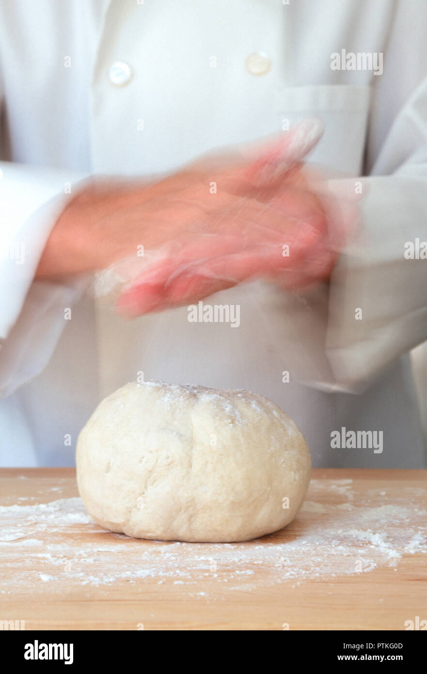 Pastry chef flouring his hand and dough, USA Stock Photo