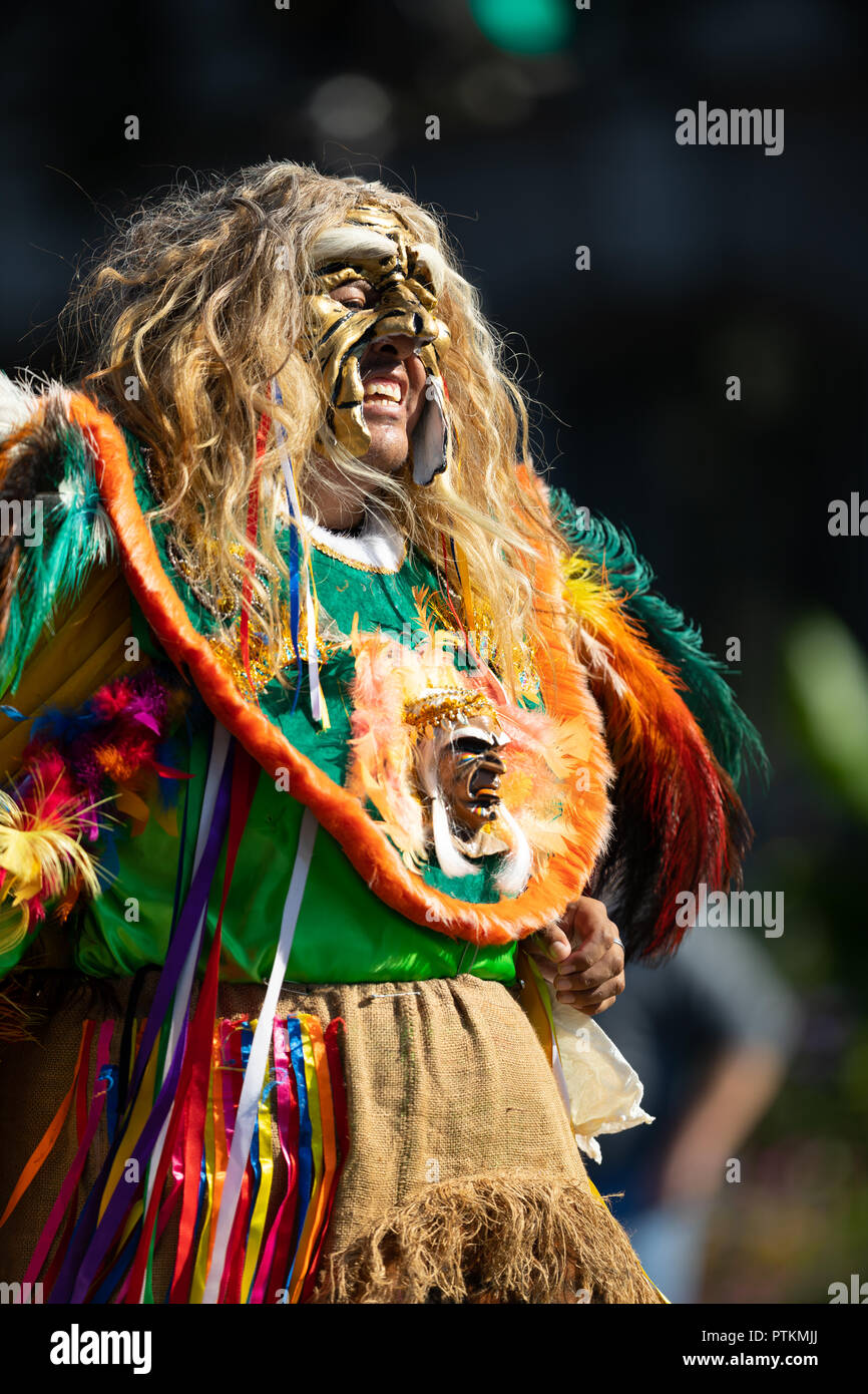 Washington, D.C., USA - September 29, 2018: The Fiesta DC Parade, Bolivian man wearing an abstract traditional outfit with a face mask and colorful fe Stock Photo