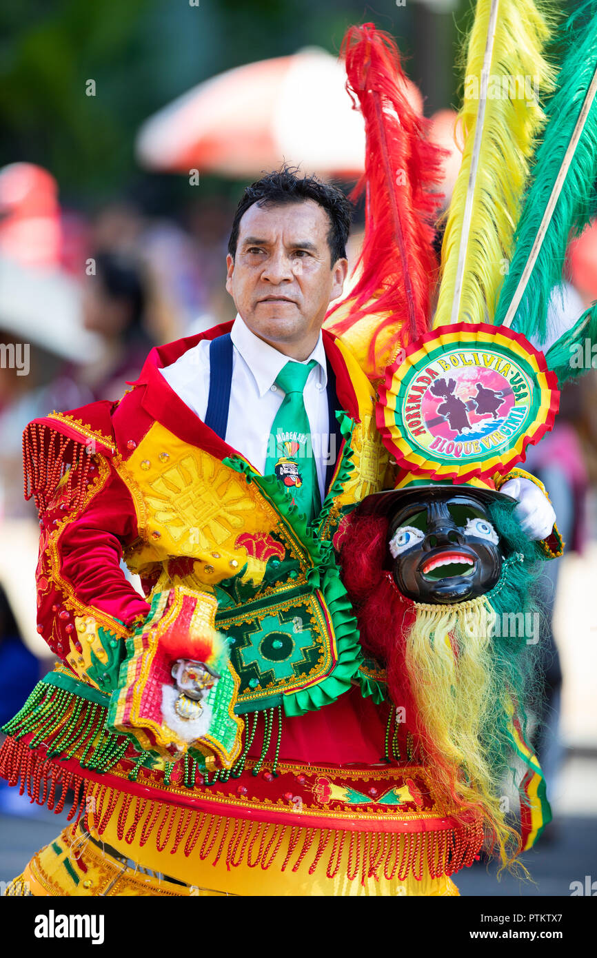Washington, D.C., USA - September 29, 2018: The Fiesta DC Parade, bolivian man wearing a colorful abstract traditional outfit with a colorful face mas Stock Photo