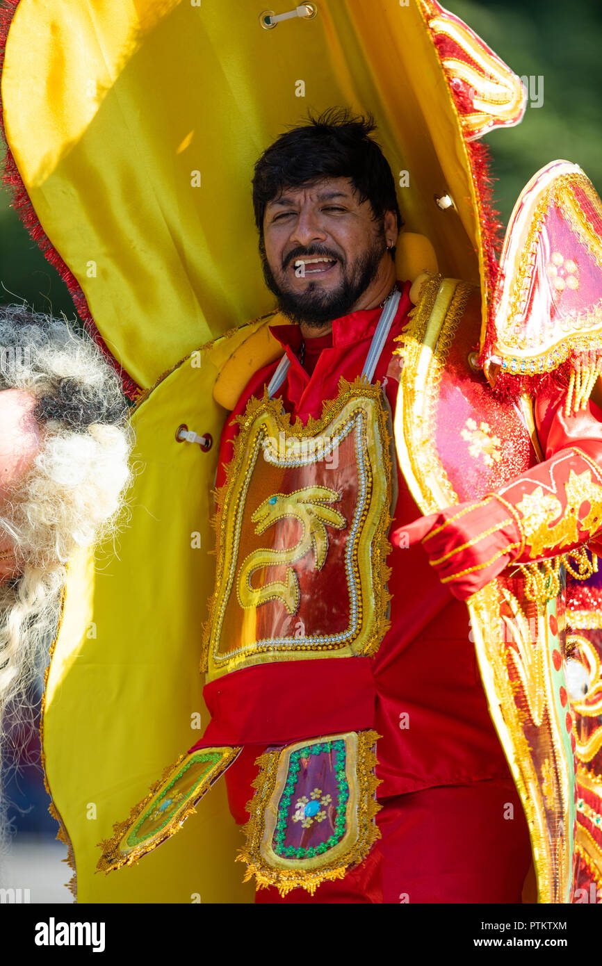 Washington, D.C., USA - September 29, 2018: The Fiesta DC Parade, bolivian man wearing a colorful abstract traditional outfit with a colorful face mas Stock Photo