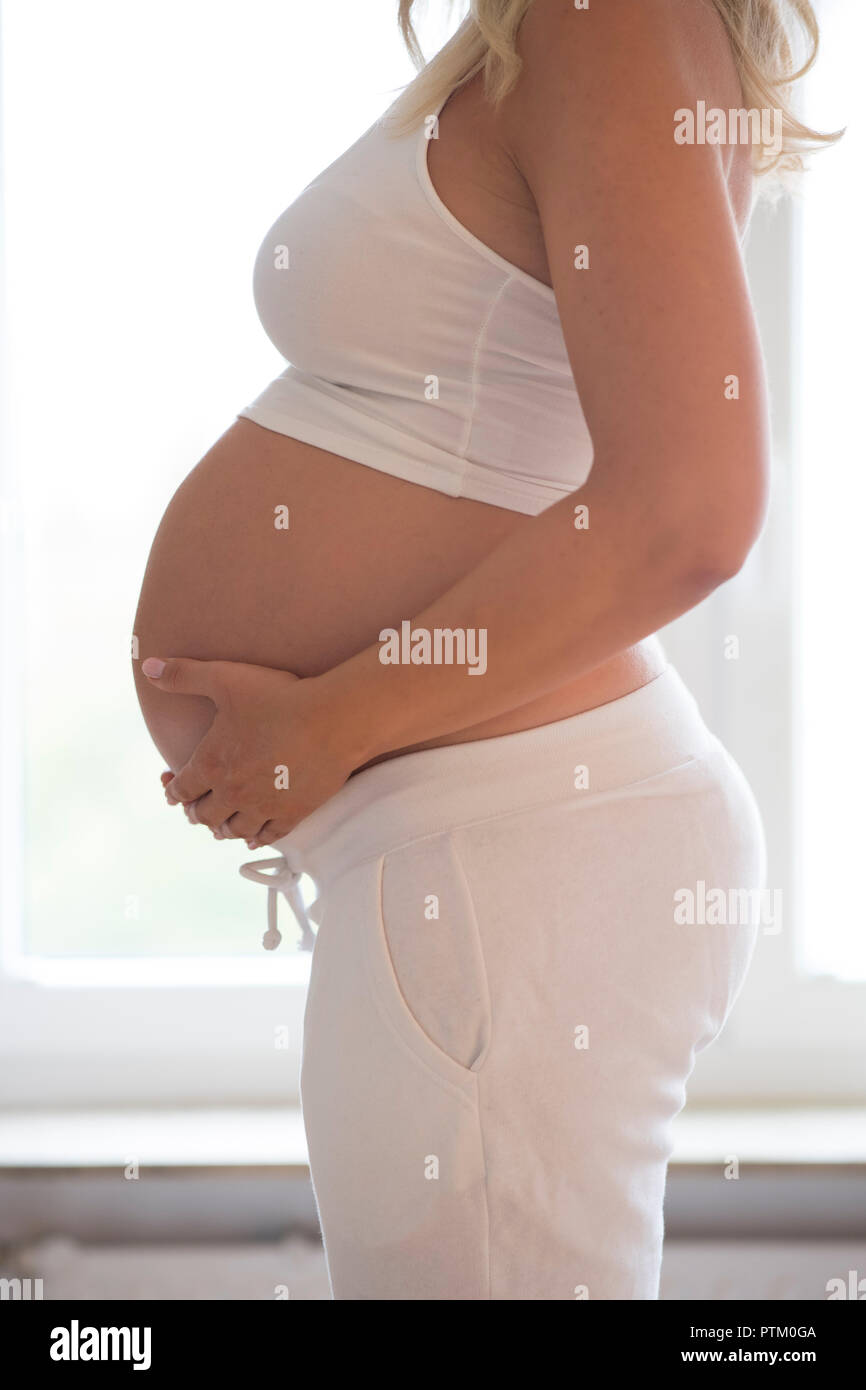 Woman nine months pregnant, Germany Stock Photo
