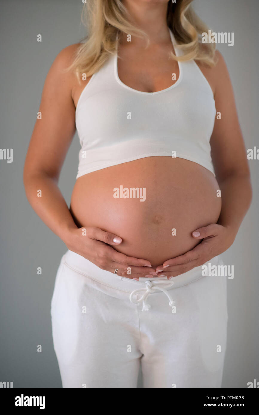 Woman nine months pregnant, Germany Stock Photo