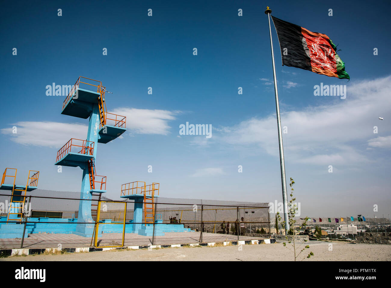 A huge flag of Afghanistan flies at the top of swimming pool hill overlooking Kabul in Afghanistan. Stock Photo