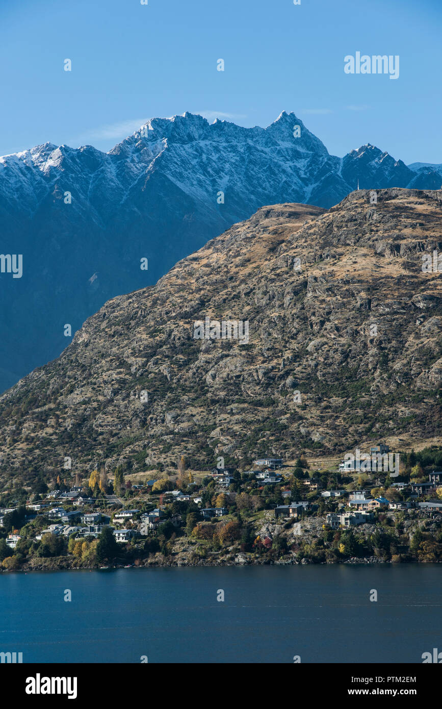 Snow covered mountains of the Remarkables in the background of Lake Wakatipu and Queenstown in New Zealand. Stock Photo