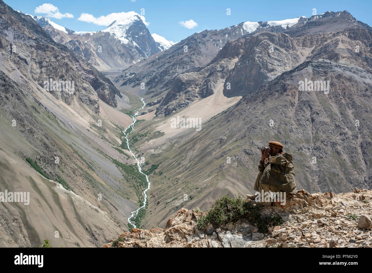 A Wakhi man looks out to the mountains in the Wakhan Corridor of Afghanistan. Stock Photo