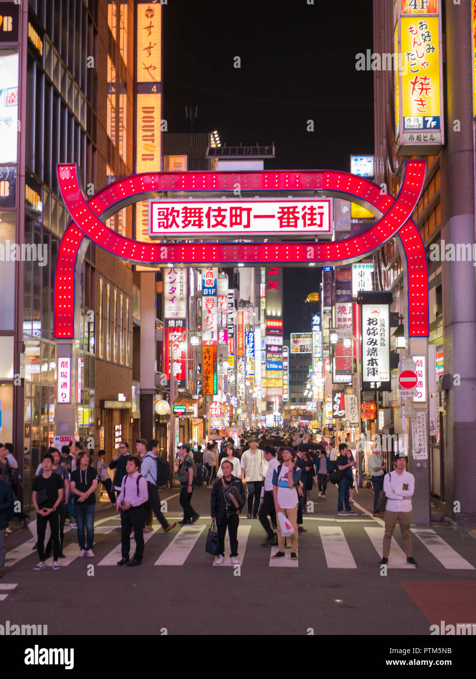 Tokyo, Japan. September 11, 2018. Crowds pass through Kabukicho in the Shinjuku district. The area is an entertainment and red-light district. Stock Photo