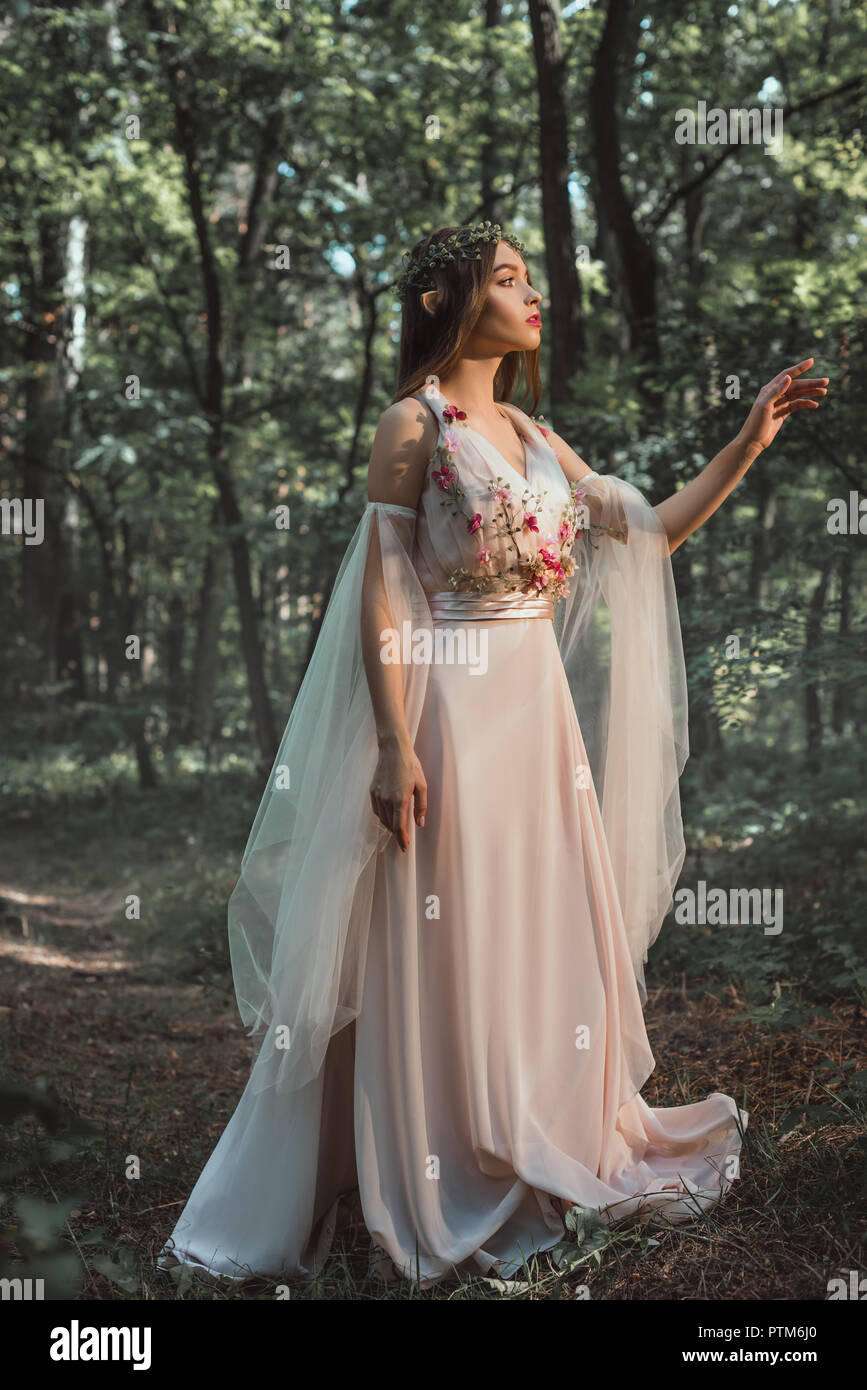 mystic elf in character in flower dress 