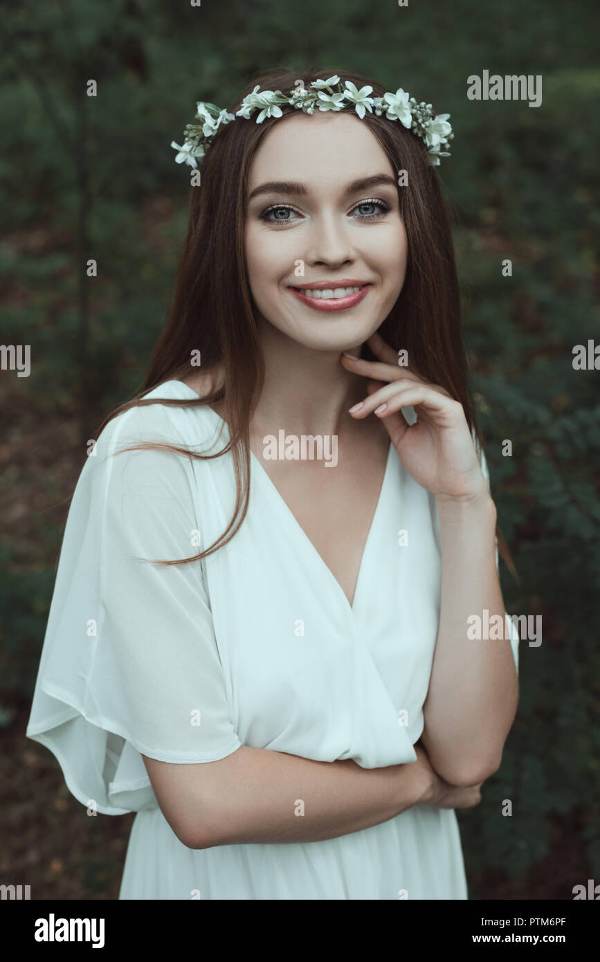 beautiful smiling girl in white dress and floral wreath Stock Photo - Alamy