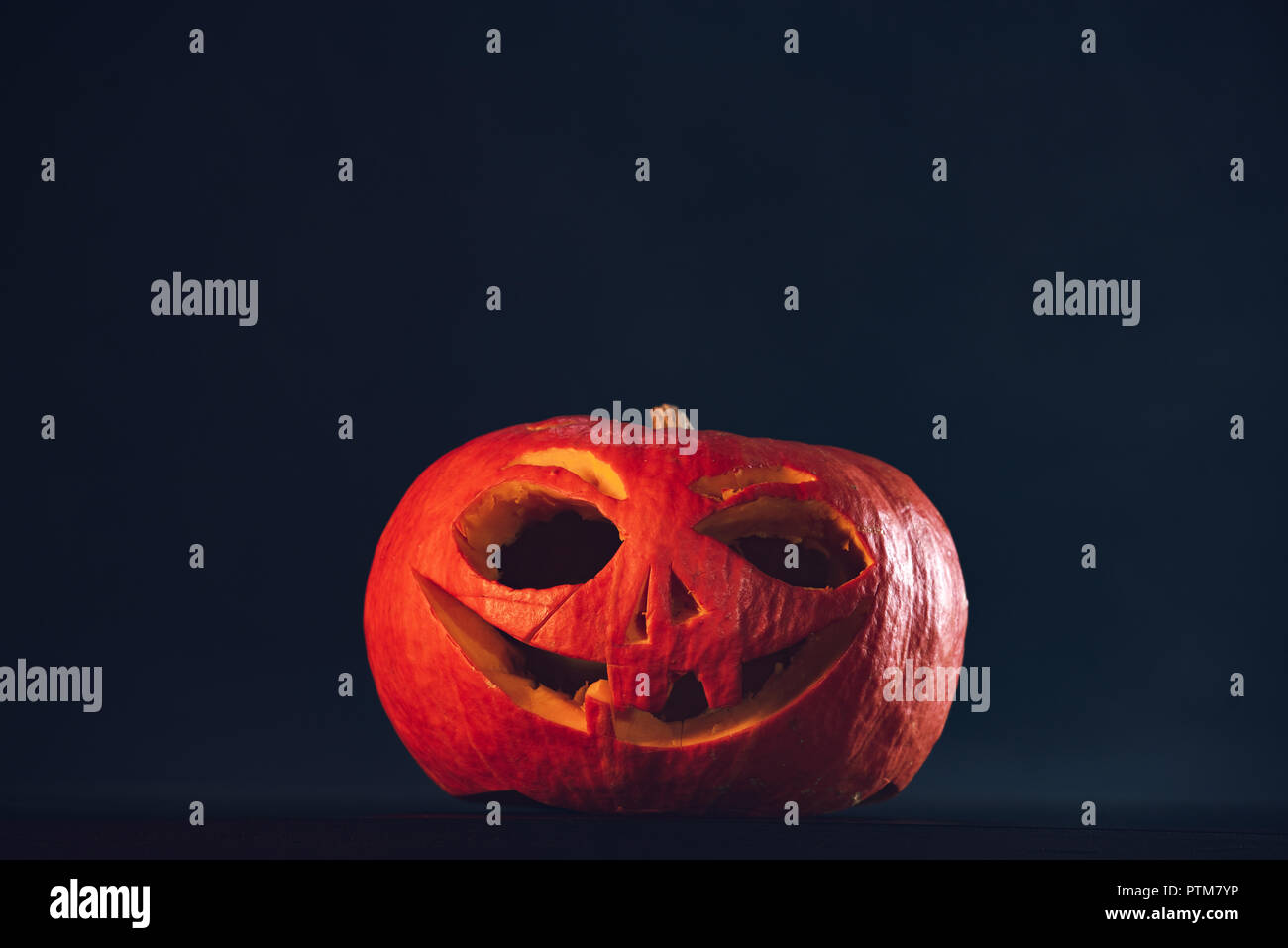Spooky Halloween carved pumpkin, jack o lantern, on black background ...