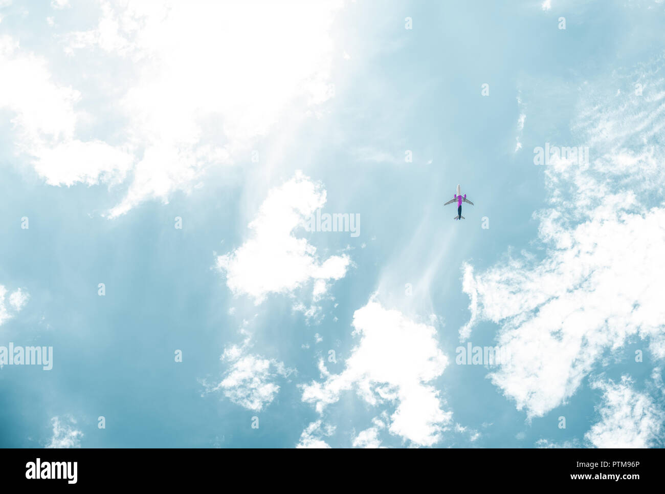 bottom view of airplane flying in blue sky with white clouds Stock ...