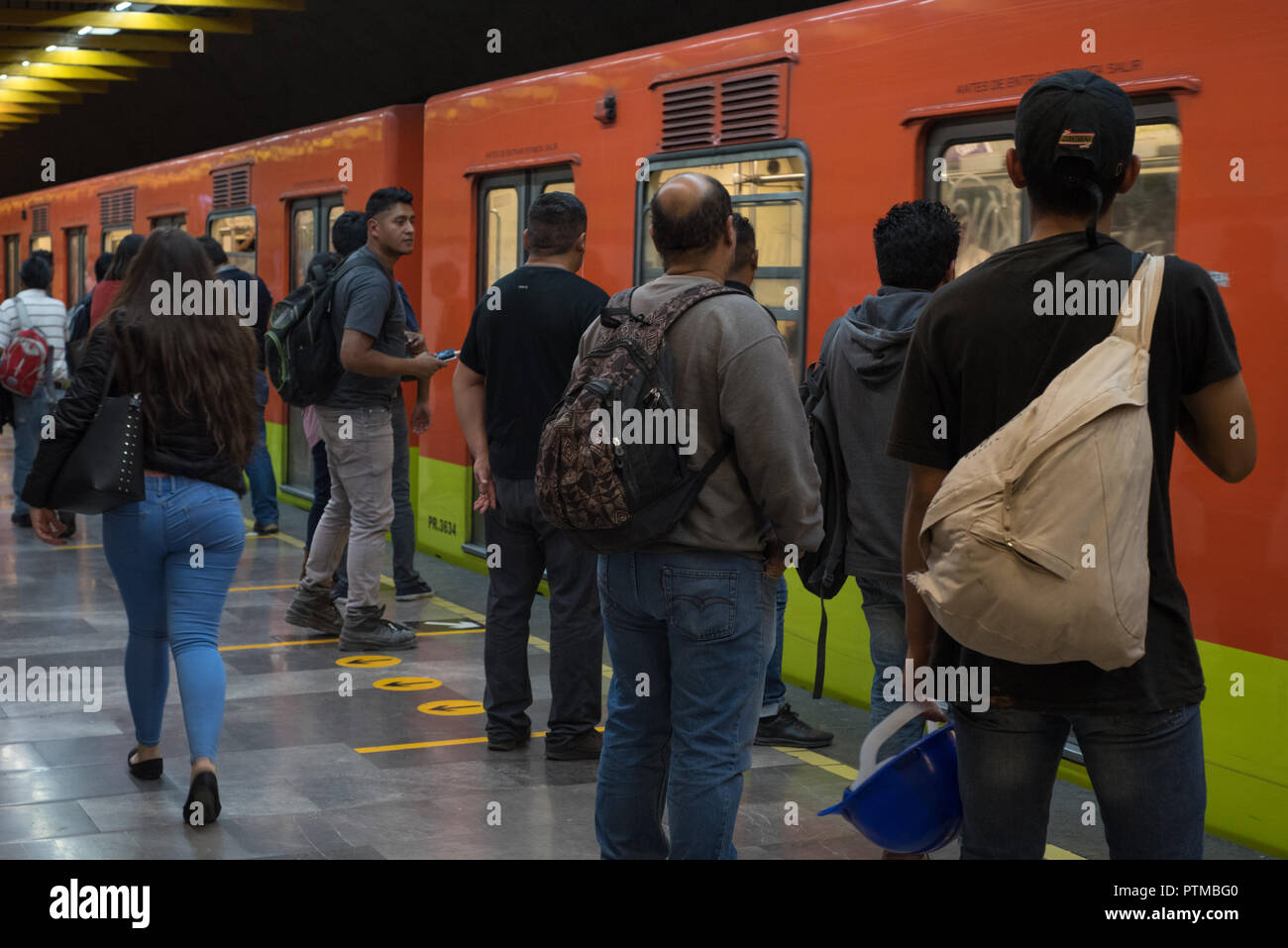 Mexican people wait to enter a train at the Mexico City Metro Stock Photo