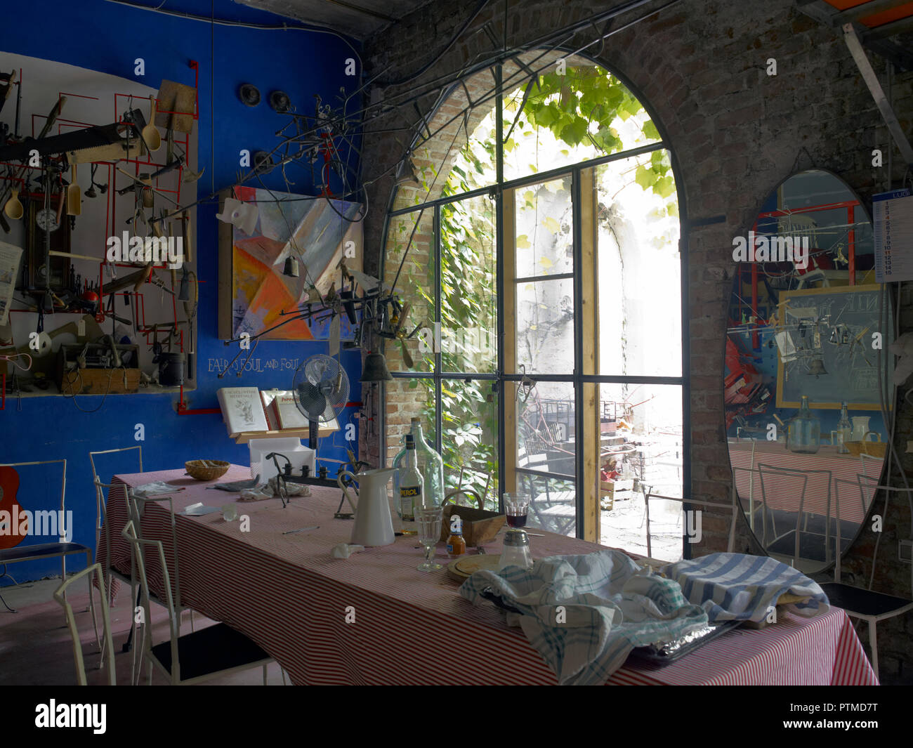 Dining room facing a garden in a a private house of a young artist in Milano, Italy Stock Photo