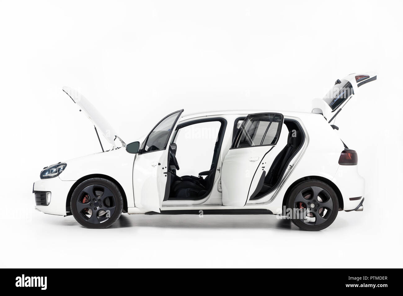 side view of new white car with open doors and open hood on white Stock Photo